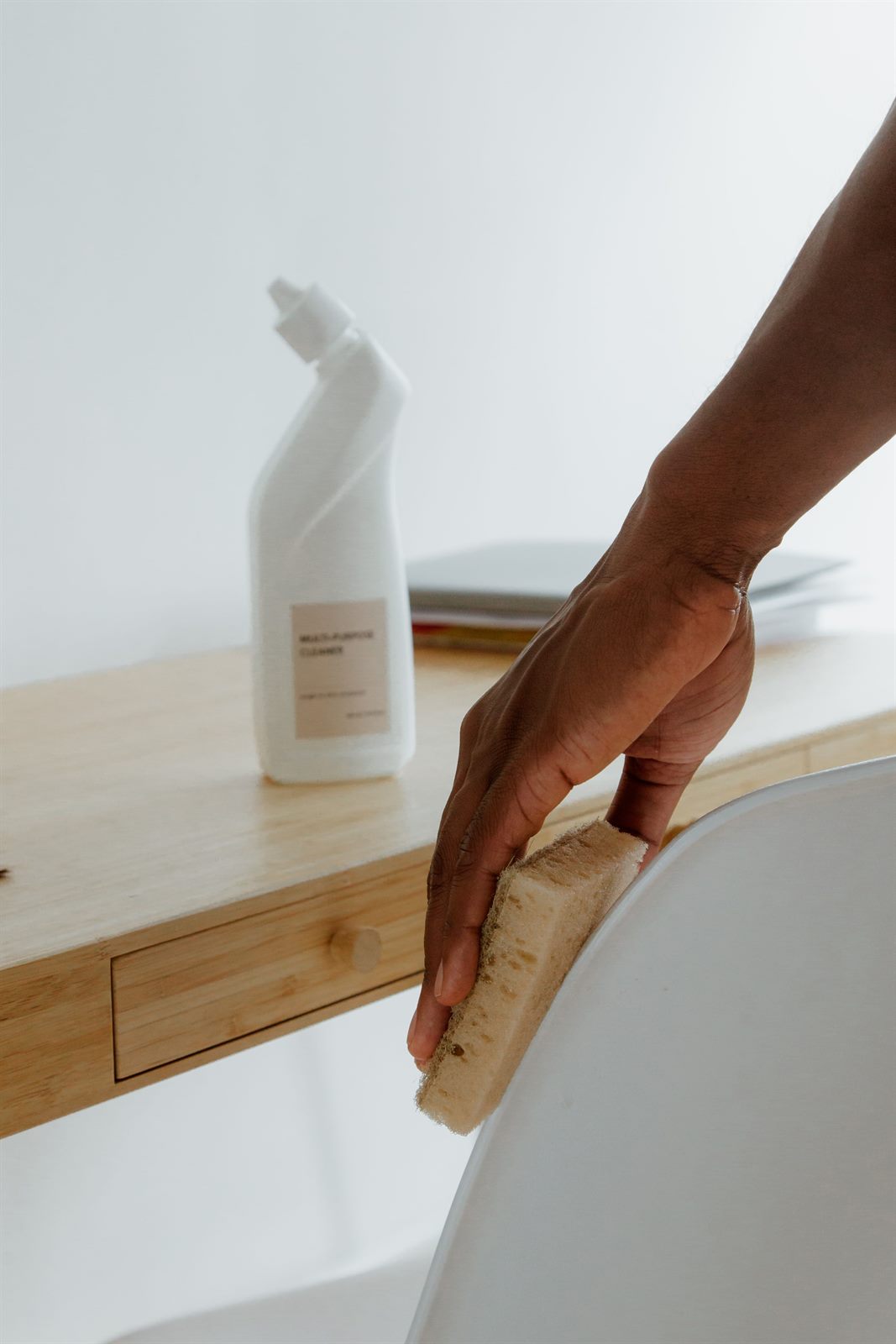 Cleaner wiping a surface with multipurpose cleaner during a move-out clean