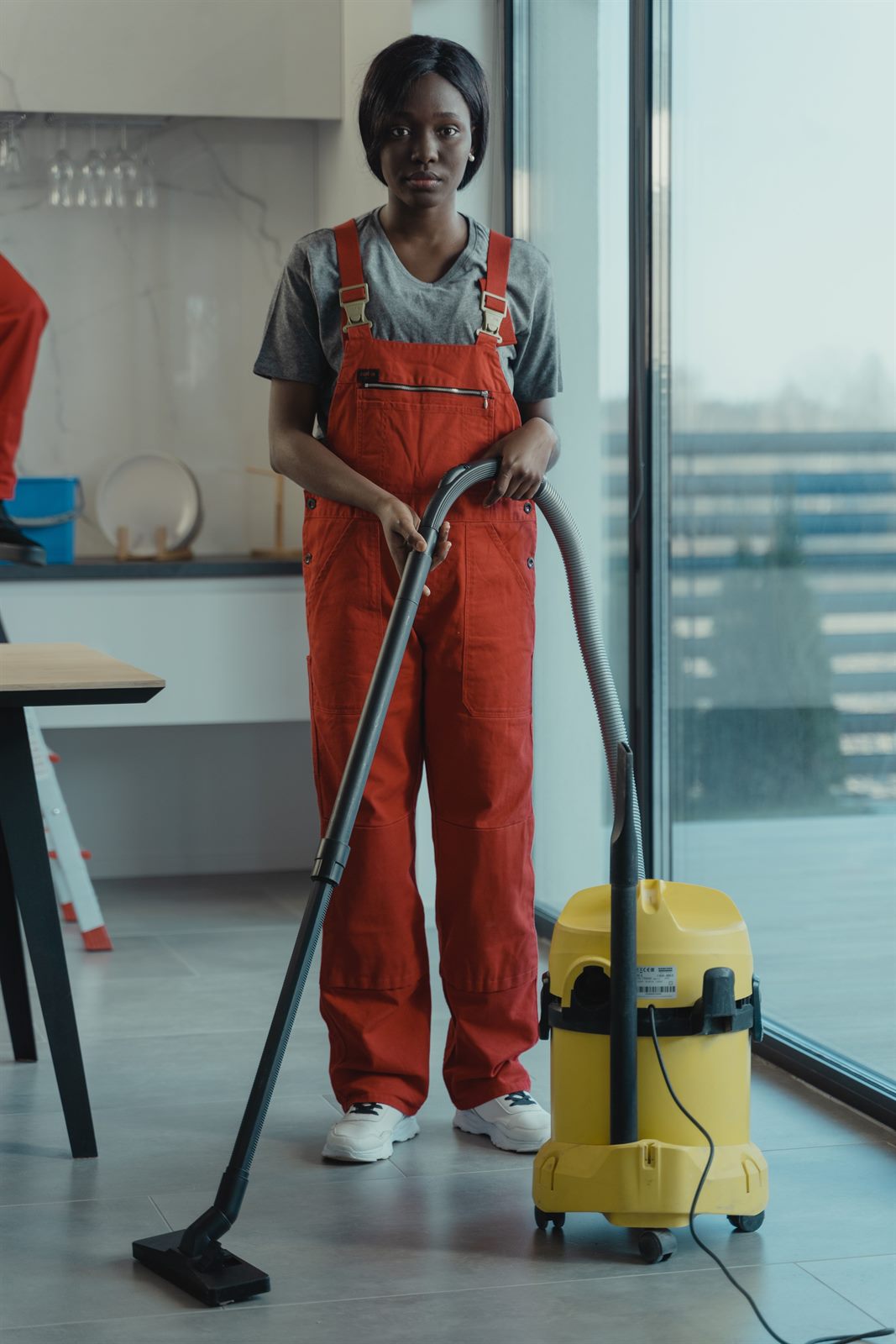 M-Pac Cleaning professional in uniform ready for a move-out and turnover cleaning job