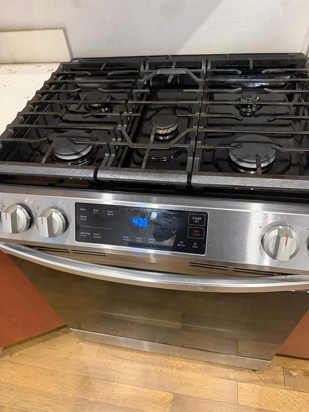 Spotless stainless steel gas range after a professional move-out kitchen cleaning in Greater Boston