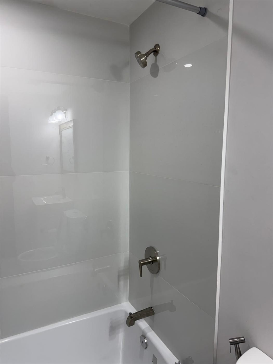 Freshly cleaned shower and tub with polished fixtures